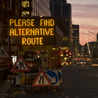Road scene with sign, Please find alternative route