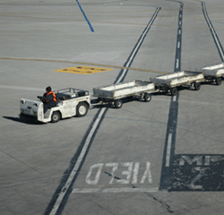 Transport truck driving across airport runway